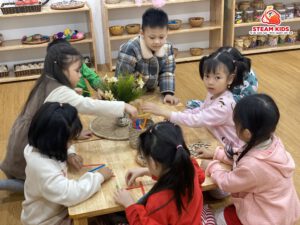 HOẠT ĐỘNG REGGIO: GHÉP CHỮ BẰNG NGUYÊN VẬT LIỆU GỖ, NẮP CHAI HỘT HẠT - Trường Mầm Non STEAM KIDS